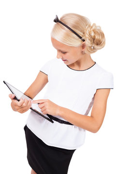 school girl with a tablet in hands smiling, picture with depth o
