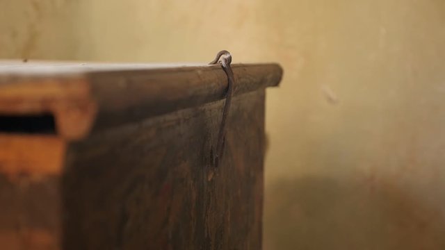 Slow motion steel latch in abandoned house room footage - Close-up movements of old chest lock part shallow DOF