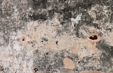 Textures of weathered stone wall background of the ancient city.