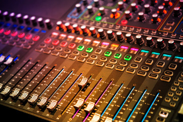 Professional sound and audio mixer control panel with buttons and sliders