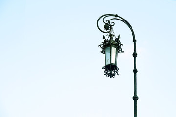 Old antique aged beautiful street lamp lantern light on a clear sky