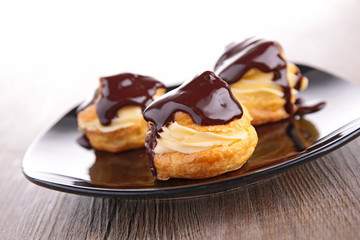 profiterole, french puff pastry with cream and chocolate