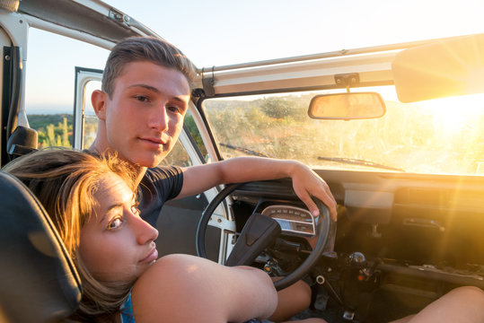Couple in a car at sunset