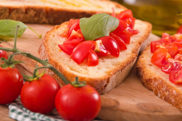 Bruschetta bread with basil and chopped tomatoes. 