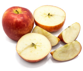 Sliced apples Kanzi, one whole, two cross section halves, slices, isolated on white background