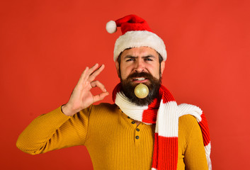 Santa in red hat shows ok sign. Man with beard