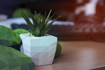 Triangulate background. Decorative flower pot on the table with blurred background
