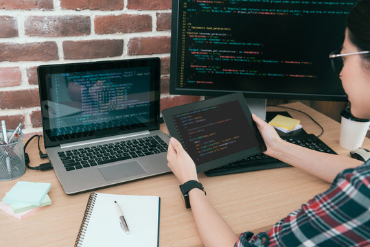 programmer looking at mobile digital tablet pad