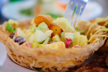 Fruit salad cream in taro basket