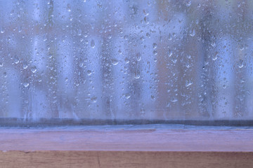 Rainy weather on glass window background