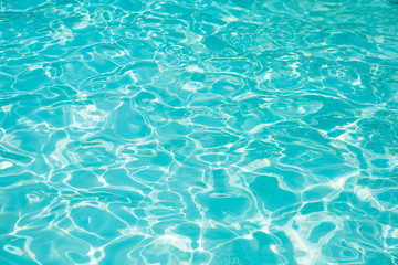 Blue and bright ripple water and surface in swimming pool , Beautiful motion gentle wave in pool