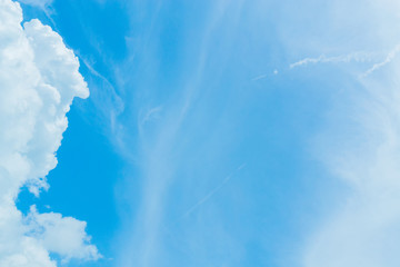 Blue sky background with tiny clouds. White fluffy clouds in the blue sky