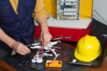 Fototapeta premium electrician fitting a quadcopter