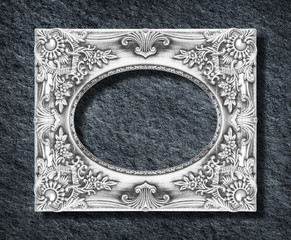 The antique silver frame ellipse on the black stone background