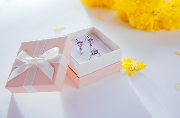 Set of silver jewellery with amethyst in the gift box with yellow flowers - Powered by Adobe