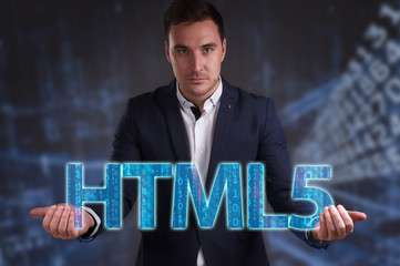 The concept of business, technology, the Internet and the network. Young businessman showing inscription: HTML5