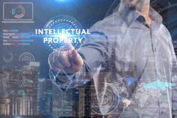 Business, Technology, Internet and network concept. Young businessman working on a virtual screen of the future and sees the inscription: Intellectual property