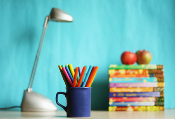Education accessories with pencils? lamp and apple