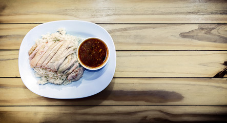 Chinese Hainan Styled Chicken Over Rice on a Wooden Background