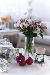 Obraz na płótnie Canvas Flowers on white table in room