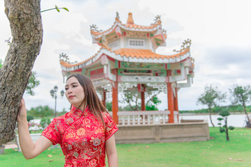 happy Chinese new year. Asian woman wearing traditional Cheongsam clothes portrait outdoor
