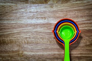 Set of Colorful Measuring Spoon on a Wooden Background