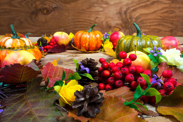 Fall door wreath with pine cones, lilac flowers and rowan berries