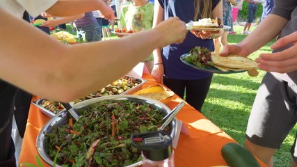 Fresh vegan food salad being served at a community event