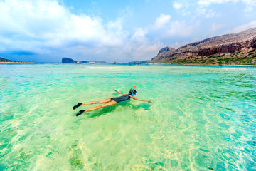 Young woman enjoying snorkeling on tropical island. Portrait of woman in clear water snorkeling