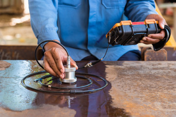 Ultrasonic test to detect imperfection or defect of steel plate in factory, NDT Inspection. © sakarin14