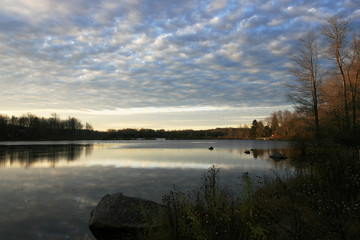 Crispy morning, sunrise on the rural lake landscape with the cloudy sky
