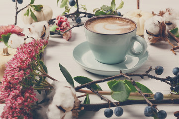 Pumpkin spice latte. Coffee cup on white wood background