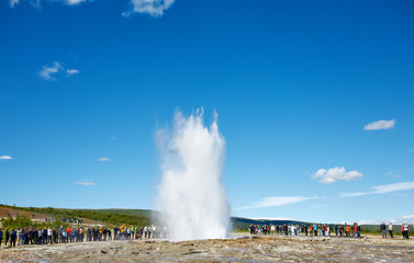 Fototapeta na wymiar Summer in Iceland. Eruption of Strokkur Geyser in Iceland. Magnificent geyser Strokkur. Fountain Geyser throws azure water every few minutes