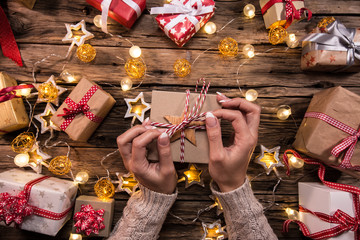 Top view of woman hands with gift box.