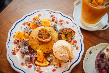 Sweet Pancakes with honey and vanilla ice cream Fruit with Orange focus on pancake