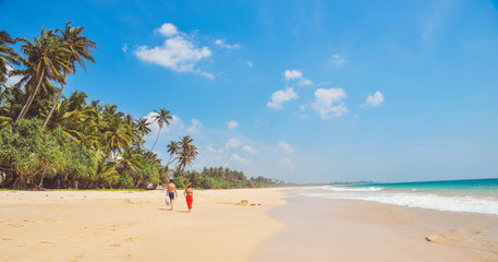 Lovers couple walking along the shore of the ocean