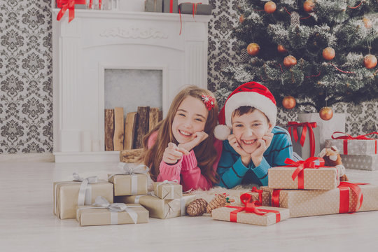 Beautiful children and christmas present indoors