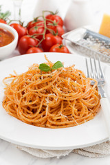 pasta with tomato sauce and ingredients, vertical, closeup