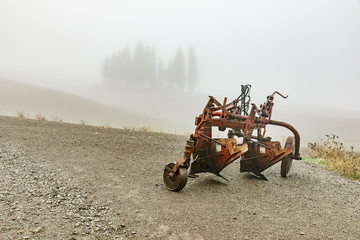 red plow parked in the field, Autumn landscape of Tuscany