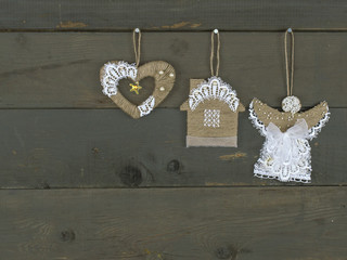 New Year handmade toys hung on a wooden background. 