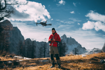 Nature  photographer flying a drone in mountains, Julian Alps, in Europe. 
