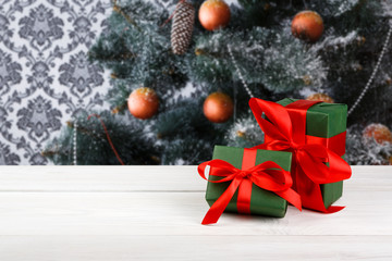 Christmas gifts on decorated tree background, holiday concept