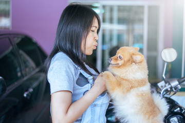 Cheerful asian young teen girl playing and happy fun with her dog at home,feeling happy and smiling face