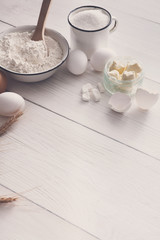 Baking ingredients on rustic white background
