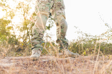 Soldier standby on the mountain with flare and bright sunlight