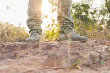 Soldier standby on the mountain with flare and bright sunlight