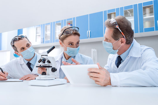 Scientists working with digital tablet