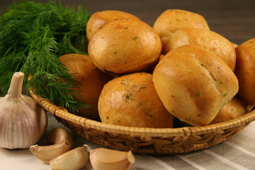 Homemade buns with garlic and dill on wooden table. Selective focus.