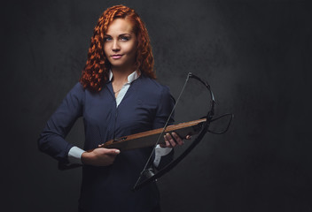 Redhead female  holds crossbow.