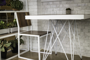 Room ambiance with white metal table and  chair